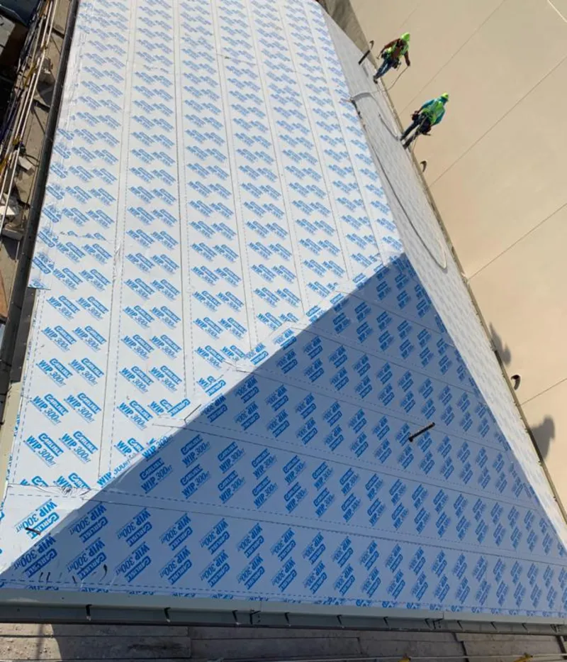 Professional roofers installing underlayment on a metal roof in Alondra Park